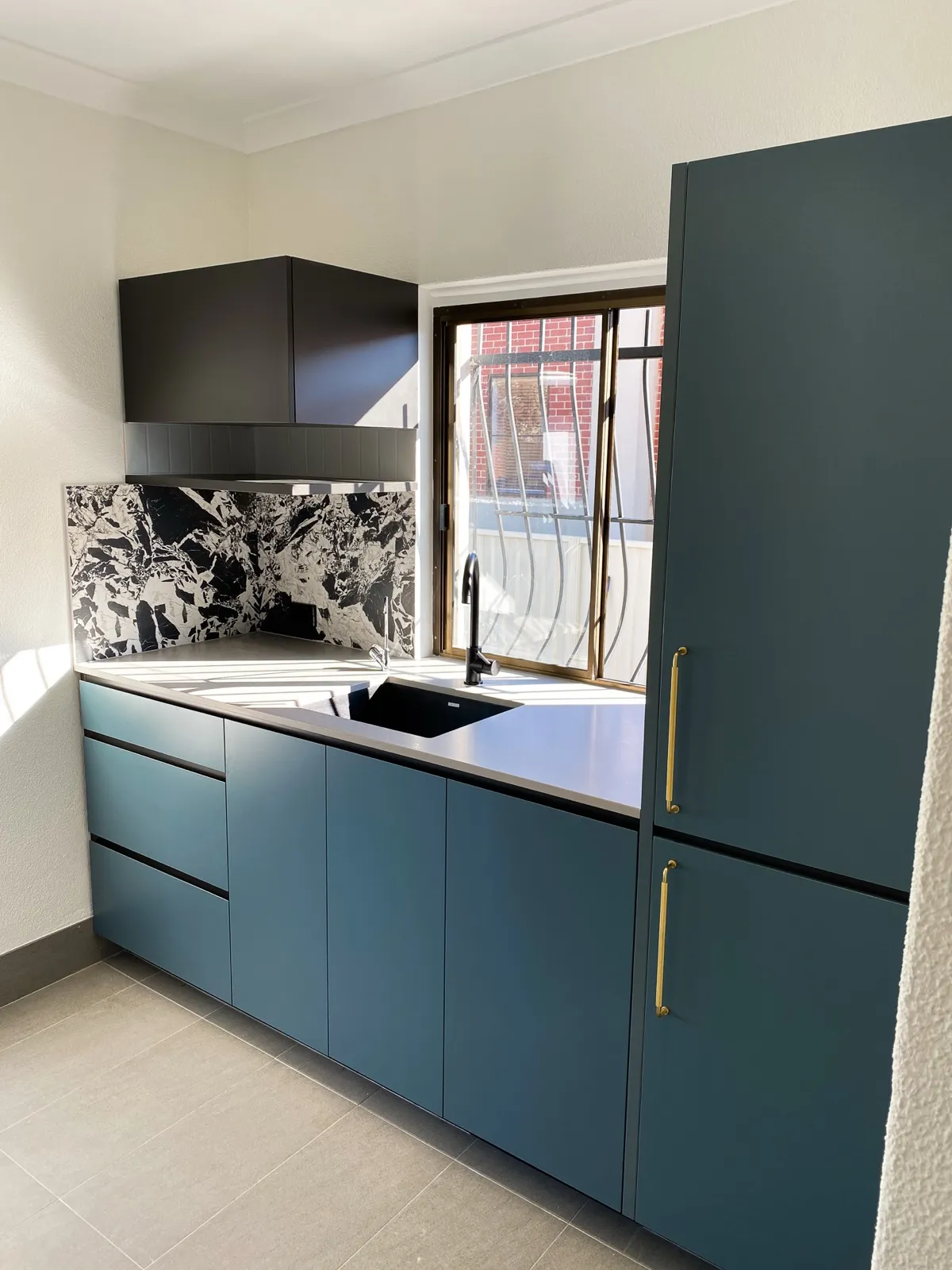Slate blue laundry, marble splashback