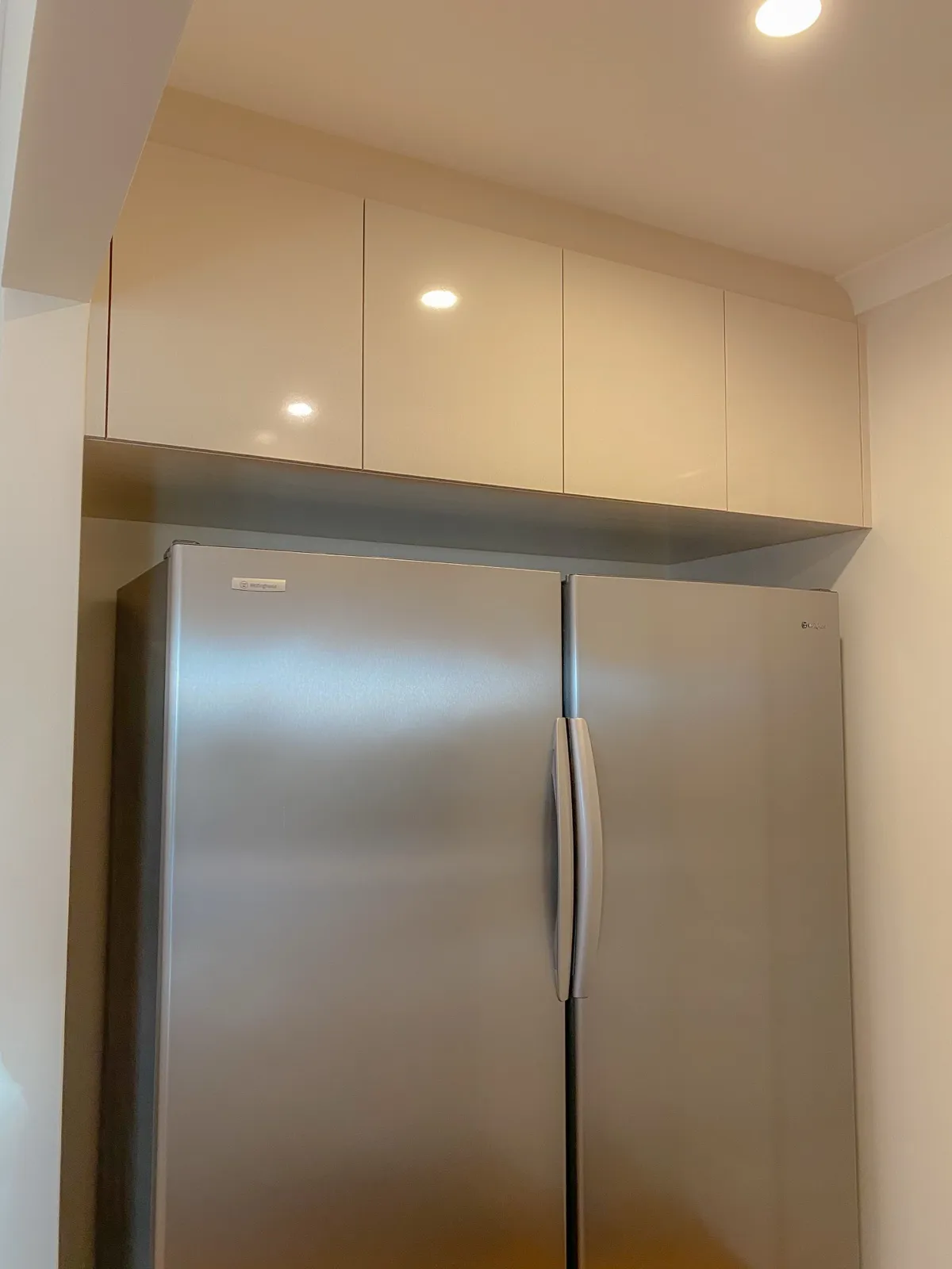 Overhead cabinets above double fridge